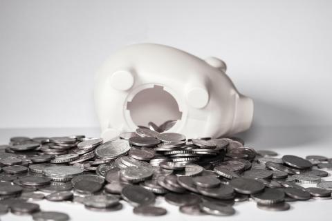 Piggy bank with money spilling out