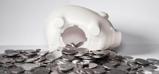 Piggy bank with money spilling out